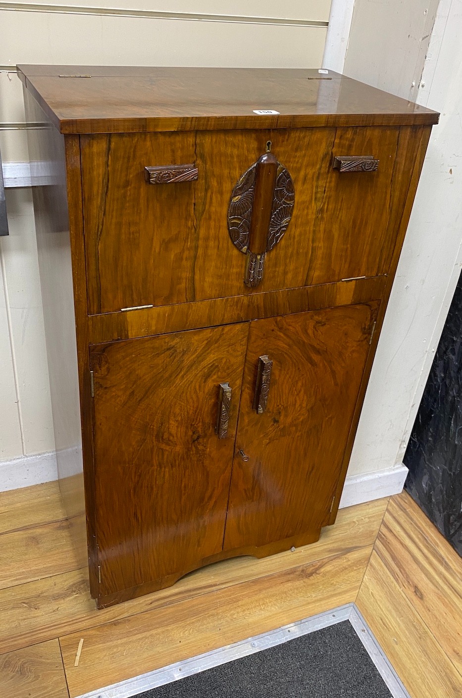 An Art Deco walnut cocktail cabinet, width 62cm, depth 37cm, height 108cm